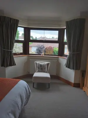 a bedroom with a bed and a chair and a window at Byerley House in Newmarket