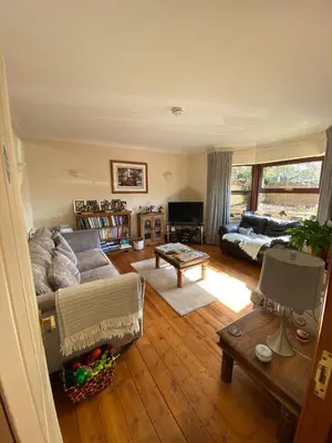 a living room with a couch and a table at Byerley House in Newmarket