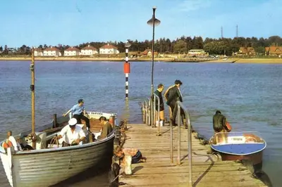 a group of people standing on a dock next to a boat at Saurden Guest Apartment in Ipswich