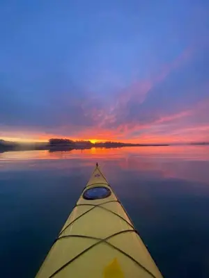 a view from a kayak on a lake with a sunset at Saurden Guest Apartment in Ipswich