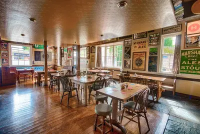 a dining room with tables and chairs in a restaurant at The Red Lion in Cambridge