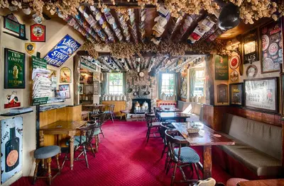 a restaurant with tables and chairs and a fireplace at The Red Lion in Cambridge