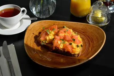 a plate of food on a table with a cup of tea at B&B Downham Hall in Wickford