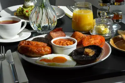 a plate of breakfast food on a table at B&B Downham Hall in Wickford