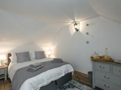 a bedroom with a bed with two towels on it at The Coach House - Ukc2365 in Watton