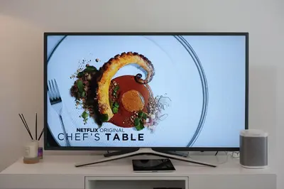 a television screen with a plate of food on it at Tailored Stays - De Havilland House in Cambridge