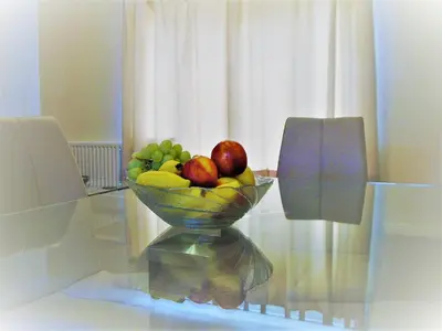a bowl of fruit sitting on a glass table at Stratford Apartment in Newmarket