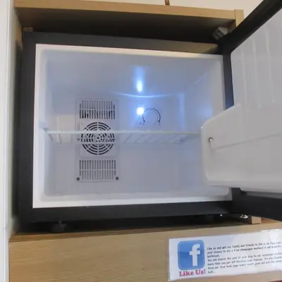 a white microwave oven sitting on top of a box at The Railway Sleeper Lodge in Colchester