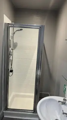a bathroom with a shower and a sink at The Railway Sleeper Lodge in Colchester