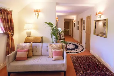 a living room with a couch with pillows at Rectory Farm in Cambridge