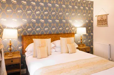 a bedroom with a large bed with two lamps at Rectory Farm in Cambridge