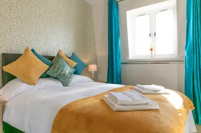 a bedroom with a bed with towels on it at Penthouse 5 mins walk to City Centre & Colleges with Balcony & Sleeps 6 in Cambridge