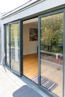 a screened in porch with sliding glass doors at Penthouse 5 mins walk to City Centre & Colleges with Balcony & Sleeps 6 in Cambridge