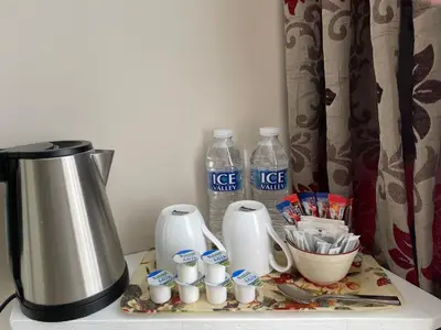 a counter with a coffee maker and bottles of water at The Sandrock in Clacton-on-Sea