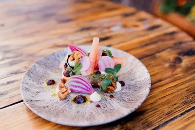a plate of food on a wooden table at The Cricketers Arms in Quendon