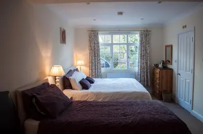 a bedroom with two beds and a window at Leverton House in Cambridge