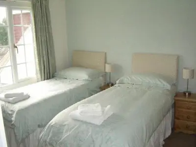two twin beds in a room with a window at Leverton House in Cambridge