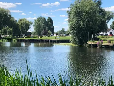 a view of a lake with a dock at Pike & Eel Hotel and Marina in Needingworth