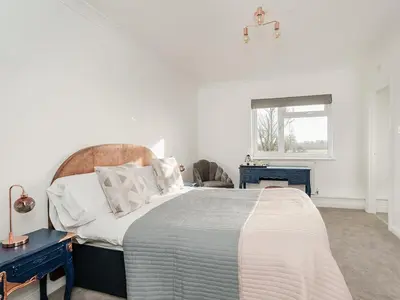 a bedroom with a large bed and a window at Pike & Eel Hotel and Marina in Needingworth