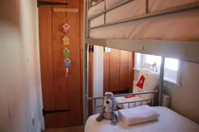 a bunk bed with a zebra doll sitting on top of it at Seaside Fisherman Cottage Aldeburgh in Aldeburgh