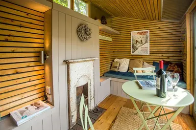 a small room with a table and a bed at Nutshell in Aldeburgh