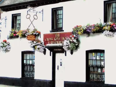 a white building with a sign in front of it at Cross Keys Hotel Chatteris in Chatteris