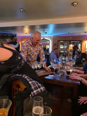 a man standing at a table with wine glasses at Cross Keys Hotel Chatteris in Chatteris