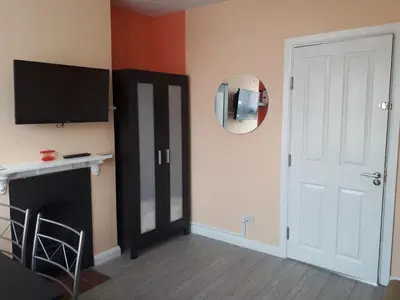 a living room with a television and a fireplace at St Giles, Thetford, 2BR House in Thetford