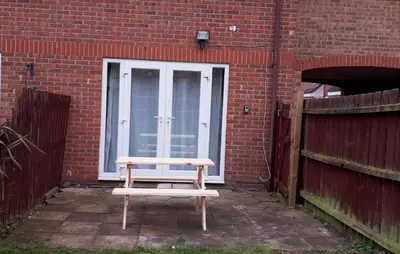 a wooden bench sitting in front of a building at Columbine, Thetford, 2BR House in Thetford