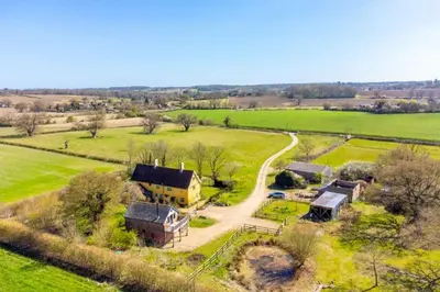 an aerial view of a house in a field at Snow Hall Barn in Peasenhall