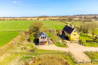 an aerial view of a house in a field at Snow Hall Barn in Peasenhall
