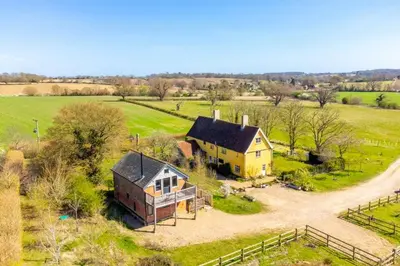 an aerial view of a house in a field at Snow Hall Barn in Peasenhall