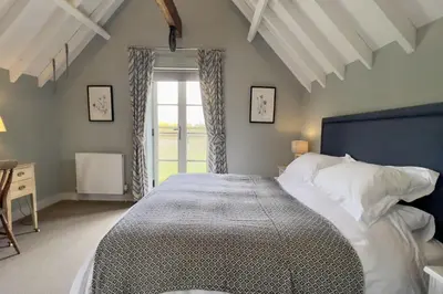a bedroom with a large bed and a window at The Parlour in Freston