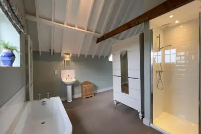 a bathroom with a bath tub and a sink at The Parlour in Freston