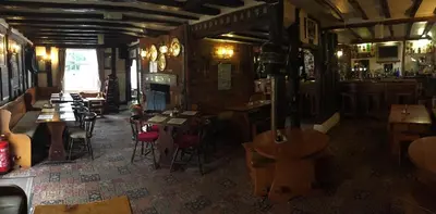 a restaurant with tables and chairs in a room at Sorrel Horse Inn in Ipswich