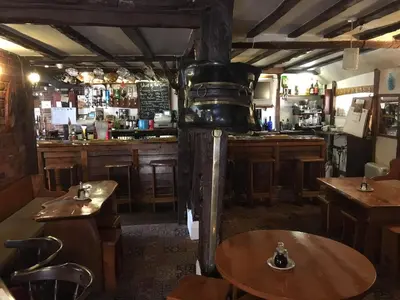 a restaurant with a bar with tables and a counter at Sorrel Horse Inn in Ipswich