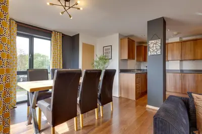 a kitchen and dining room with a table and chairs at Pass the Keys Spacious and Modern Flat with own Car Park in Cambridge