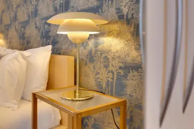 a lamp on a table next to a bed at Pass the Keys Spacious and Modern Flat with own Car Park in Cambridge