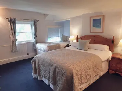 a hotel room with two beds and a window at The Crown House Inn in Great Chesterford