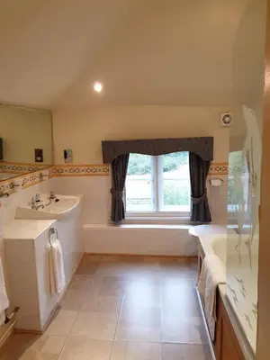 a bathroom with a sink and a window at The Crown House Inn in Great Chesterford