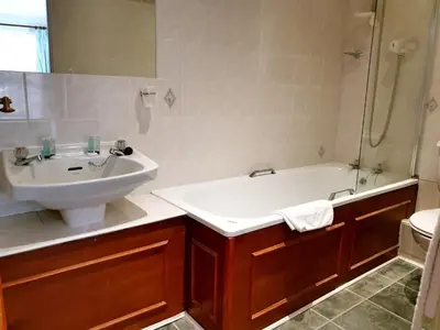 a bathroom with a sink and a bath tub and a sink at The Crown House Inn in Great Chesterford