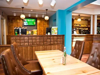 a table in a restaurant with a bar at YHA Cambridge in Cambridge