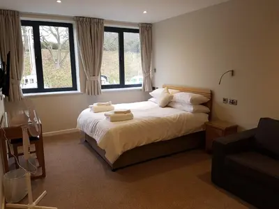 a bedroom with a bed with two towels on it at The Shipwreck Loft in Shotley Gate