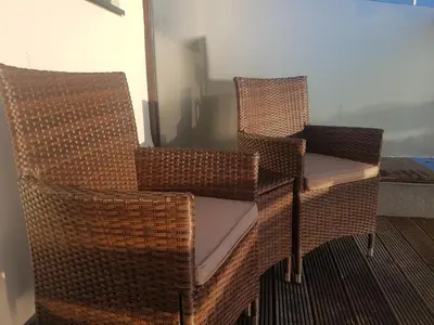 two wicker chairs sitting in a room at The Shipwreck Loft in Shotley Gate
