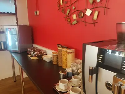 a kitchen with a counter with cups and a refrigerator at The Shipwreck Loft in Shotley Gate