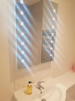 a bathroom with a sink and a mirror at The Shipwreck Loft in Shotley Gate