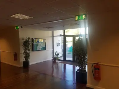 an empty room with two potted plants in front of a door at The Shipwreck Loft in Shotley Gate
