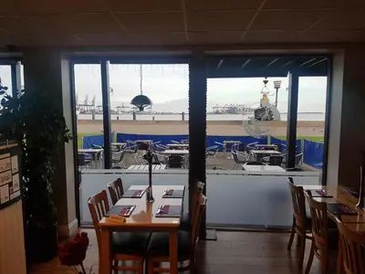 a dining room with a table and a view of the ocean at The Shipwreck Loft in Shotley Gate