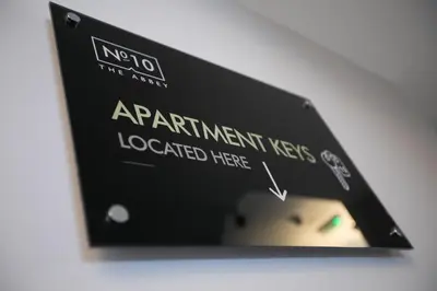a sign that reads appointment fees localized here at Apartments at Number 10 The Abbey in Norwich