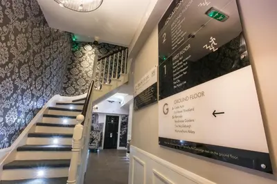 a staircase in a building with a sign on the wall at Apartments at Number 10 The Abbey in Norwich